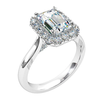 A platinum or white gold emerald cut diamond cluster halo solitaire engagement ring