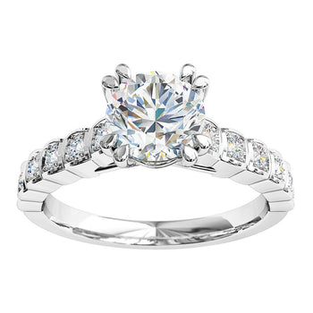 A platinum or white gold double claw cushion cut diamond solitaire engagement ring with diamonds on the band in a bezel setting