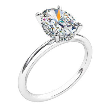 A platinum or white gold oval cut diamond solitaire engagement with a hidden halo