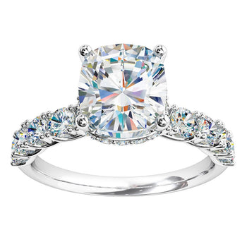 A platinum or white gold cushion cut diamond solitaire engagement ring with diamonds on the band 
