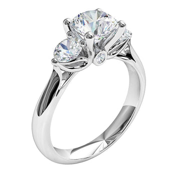 A platinum or white gold round brilliant cut diamond trilogy solitaire engagement ring