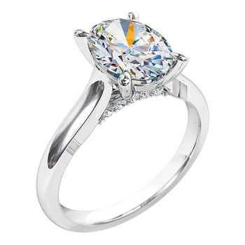 A platinum or white gold oval cut diamond solitaire engagement ring with diamonds on the bridge 
