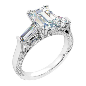 A platinum or white gold emerald cut diamond solitaire trilogy engagement ring with two baguette diamonds detailed in a milgrain finish