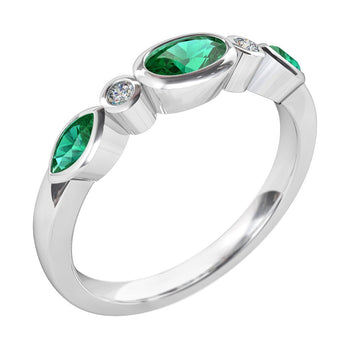 A platinum or white gold women's wedding ring featuring emerald gemstones and round brilliant cut diamonds
