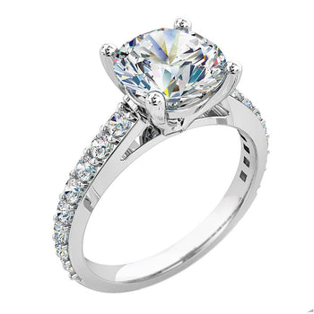 A platinum or white gold round brilliant cut diamond solitaire with sides engagement ring
