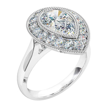 A platinum or white gold pear shaped diamond milgrain bezel set vintage cluster halo engagement ring