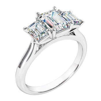 A platinum or white gold emerald cut diamond trilogy solitaire engagement ring with two matching emerald cut diamonds