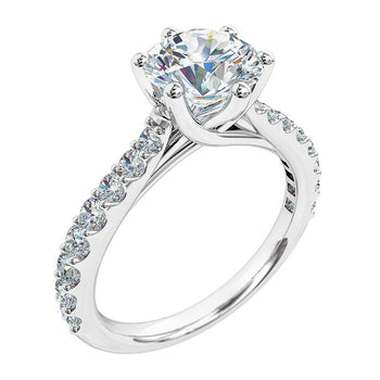 A platinum or white gold round brilliant cut diamond solitaire with side stones engagement ring