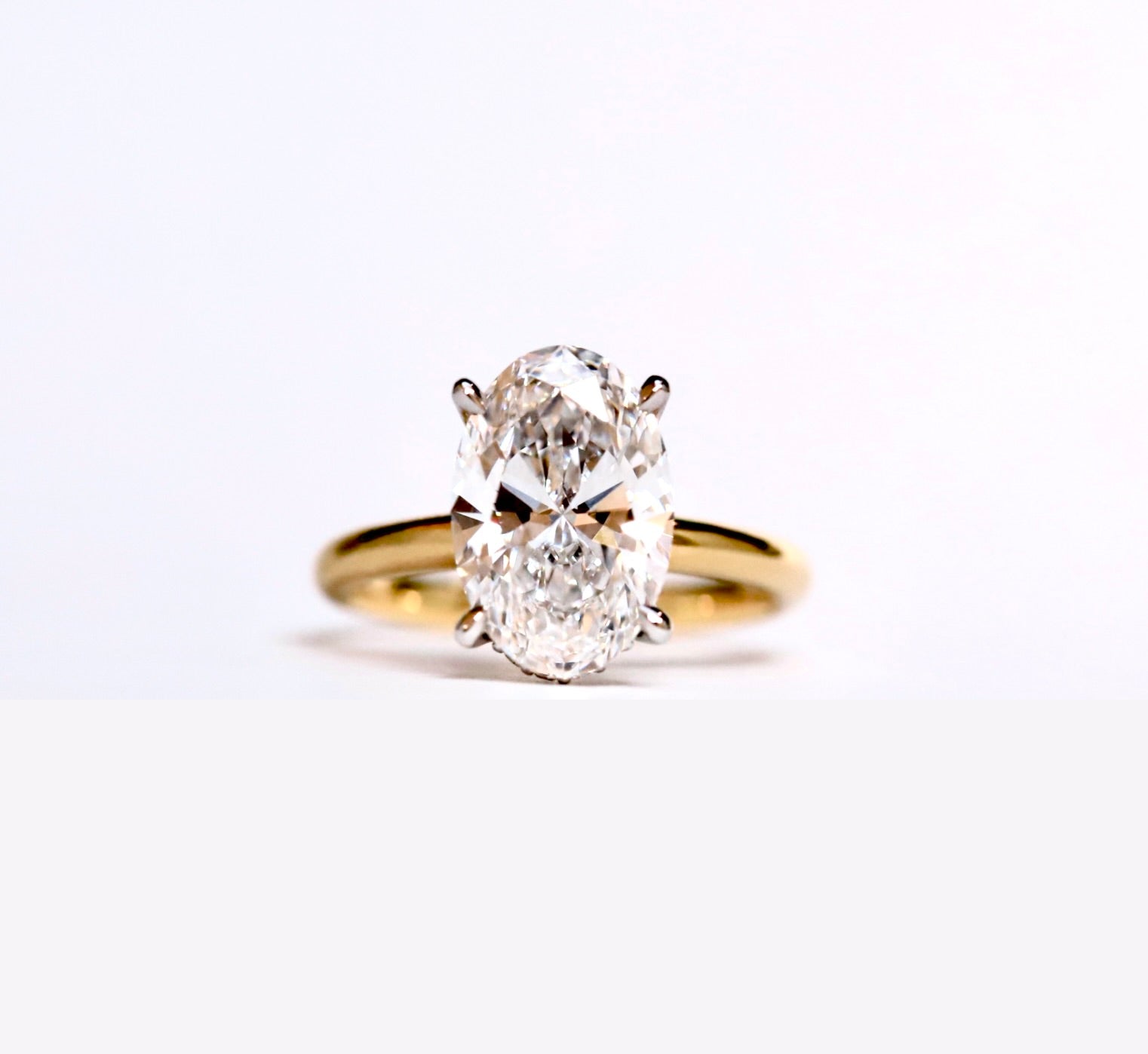 The Classic Hidden Halo Oval Engagement Ring in Yellow gold