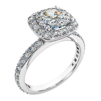 A platinum or white gold cushion cut diamond halo cluster engagement ring with diamonds on the band
