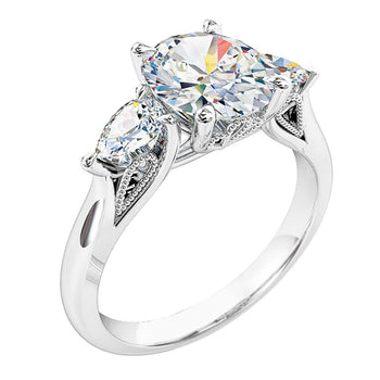 A platinum or white gold cushion cut diamond solitaire trilogy engagement ring with pear cut diamond sides