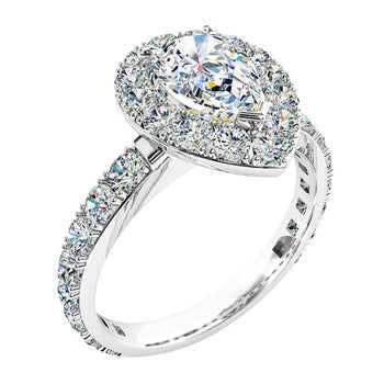 A platinum or white gold pear cut diamond halo cluster engagement ring with diamonds on the band