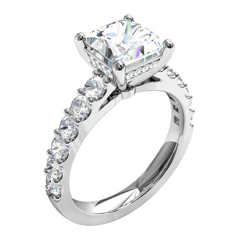 A platinum or white gold princess cut diamond solitaire engagement ring with diamonds on the band and a hidden halo