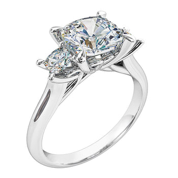 A platinum or white gold cushion cut diamond trilogy solitaire engagement ring with two accompanying cushion cut diamonds