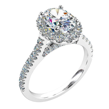 A platinum or white gold oval cut diamond cluster halo engagement ring with diamonds on the band and along the bridge