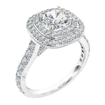 A platinum or white gold cushion cut diamond double halo engagement ring with round brilliant cut diamonds on the band and bridge