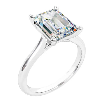 A platinum or white gold emerald cut diamond solitaire engagement ring 
