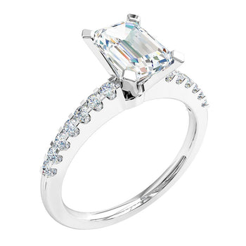 A platinum or white gold emerald cut diamond solitaire with side stones engagement ring
