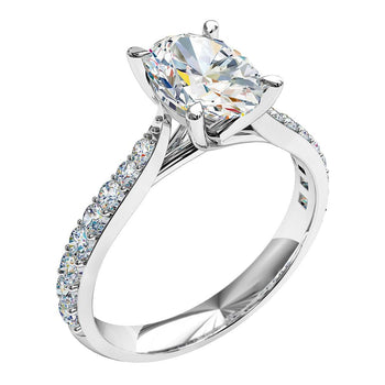 A platinum or white gold oval cut diamond solitaire engagement ring with diamonds on the band in a shared claw setting