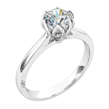 A platinum or white gold round cut diamond six claw solitaire engagement ring