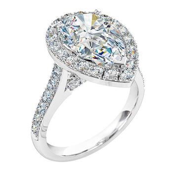 A platinum or white gold pear shaped diamond cluster halo engagement ring with diamonds on the band and under the bridge