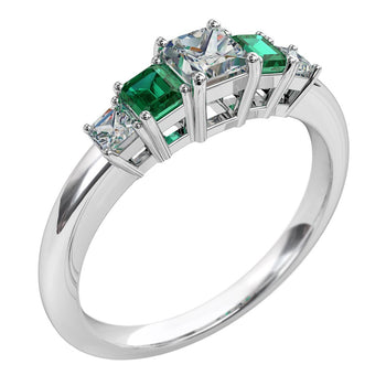 A platinum or white gold women's diamond and emerald gemstone wedding ring