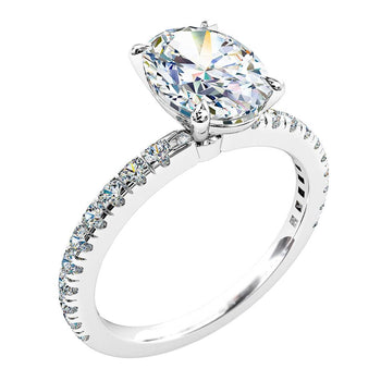 A platinum or white gold oval cut diamond solitaire engagement ring with diamonds on the band