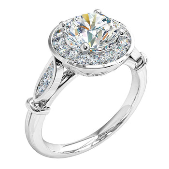 A platinum or white gold round brilliant cut diamond halo engagement ring complimented by a grain set diamond band