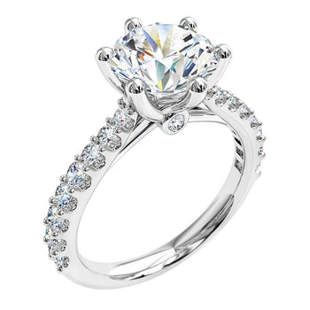 A platinum or white gold round brilliant cut diamond six-claw solitaire engagement ring with diamonds on the band