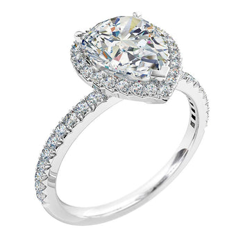 A platinum or white gold pear shaped diamond halo engagement ring with diamonds on the band