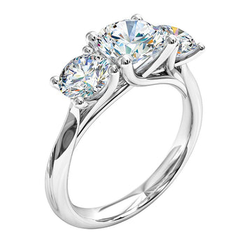A platinum or white gold round brilliant cut diamond trilogy solitaire engagement ring