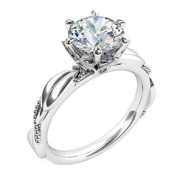 A platinum or white gold round brilliant cut diamond solitaire engagement ring with a polished milgrain design on the band and coronet