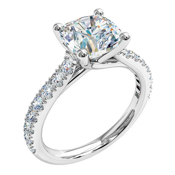 A platinum or white gold cushion cut diamond solitaire engagement ring with diamonds on the band