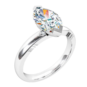 A platinum or white gold marquise brilliant cut diamond solitaire engagement ring