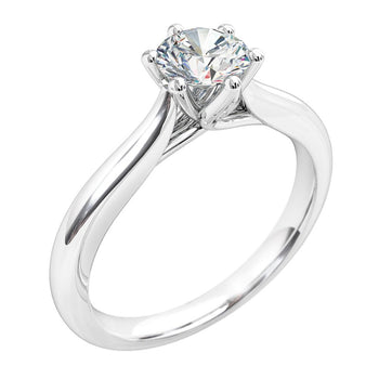 A platinum or white gold round brilliant cut diamond solitaire engagement ring