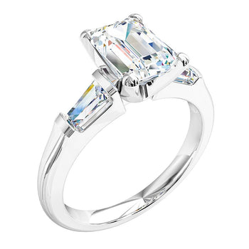 A platinum or white gold emerald cut diamond solitaire trilogy engagement ring with two matching tapered baguette diamonds